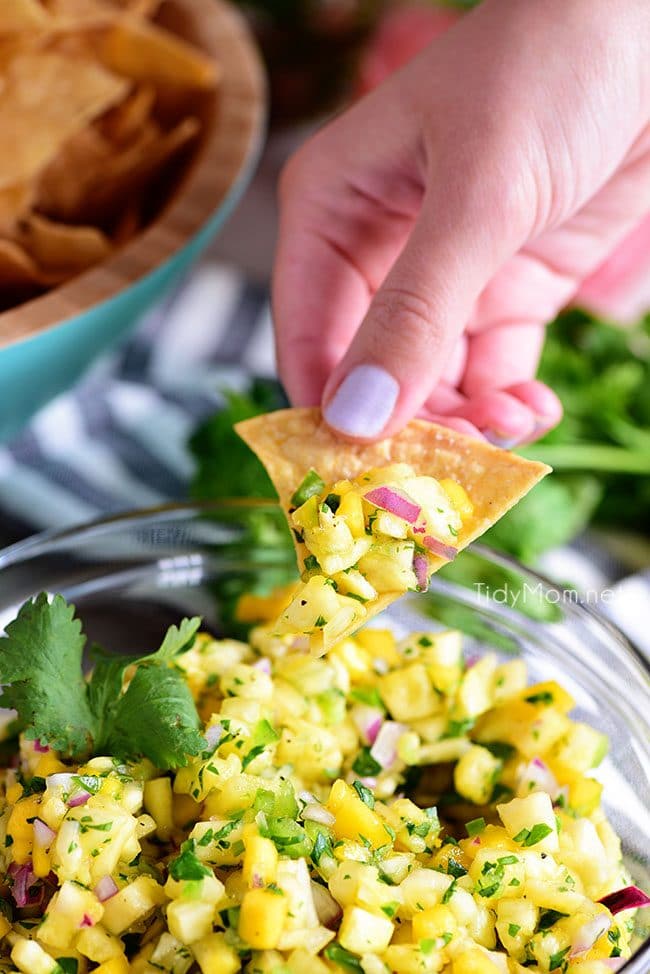 A tropical fruit salsa with a kick of jalapeno that will knock your socks off! This Pineapple Mango Salsa recipe is the perfect addition to any chicken, pork, fish, or tacos. 