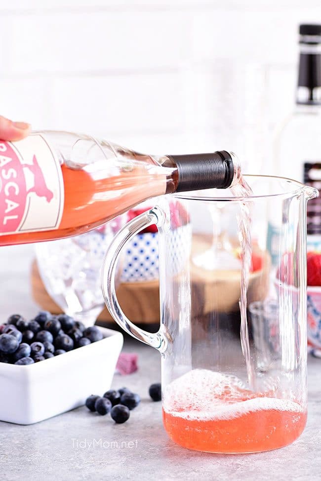 pouring rosé for a Pink Summer Sangria with rosé.