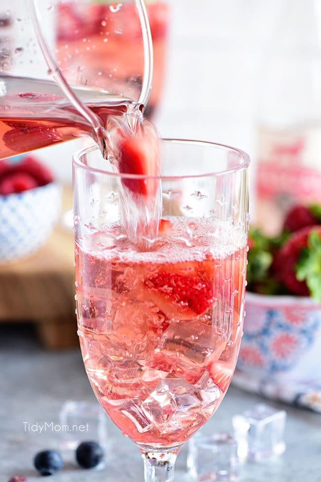 Pouring a Rosé Summer Sangria with berries.