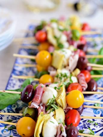 Wow your guests with bright and flavorful antipasto skewers. An easy make-ahead appetizer with a new delicious discovery in every bite. Perfect for any occasion, this party food comes together fast and is endlessly customizable. Print the recipe at TidyMom.net