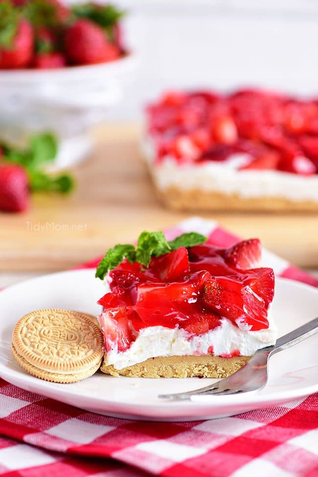 Strawberries and Cream Magic Bars made with fresh glazed strawberries and a sweet cream cheese layer with a Golden Oreo cookie crust! Chill for a tasty summer dessert! 