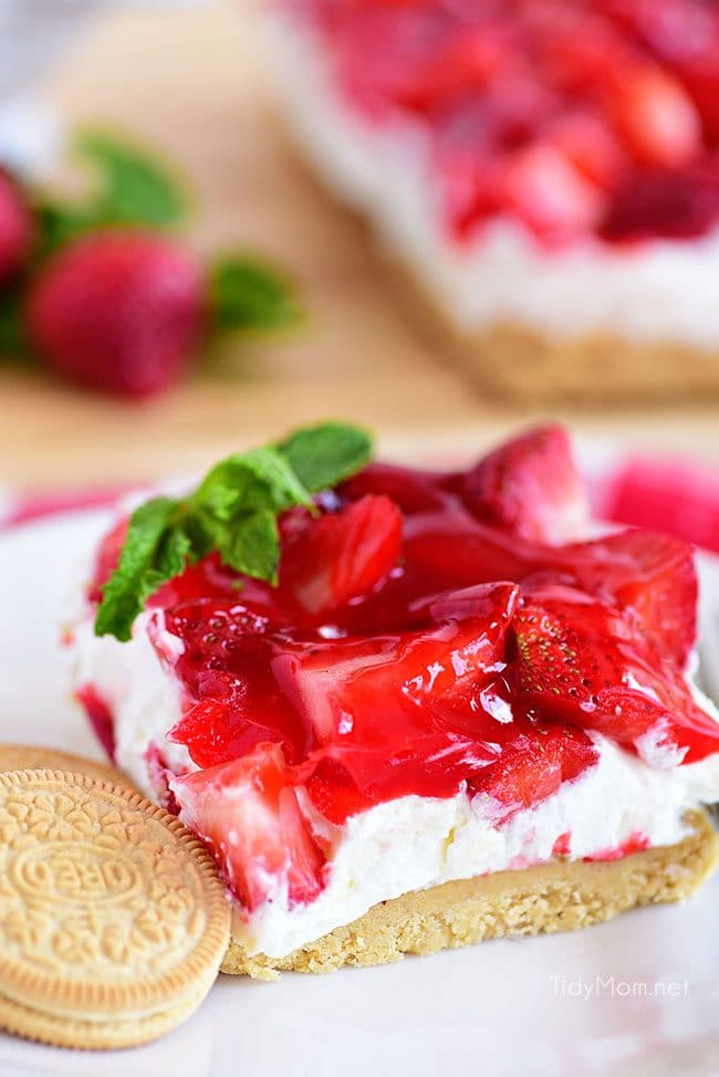 Strawberries and Cream Magic Bars made with fresh strawberries and a sweet cream cheese layer with a Golden Oreo cookie crust! Chill for a tasty summer dessert! 