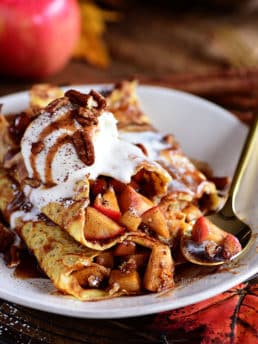 Apple Pie Crepes are thin french pancakes filled with a gooey caramel apple compote and toasted cinnamon pecans. Top with ice cream for the perfect dessert crepes.
