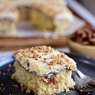 Caramel Butter Pecan Cake With Bourbon Frosting sliced on a plate