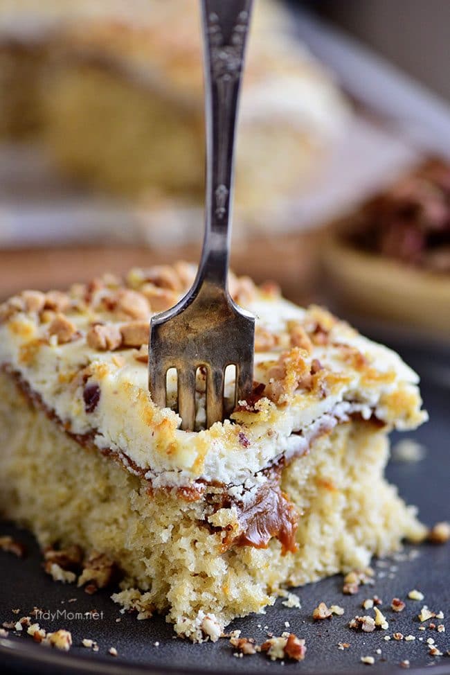 fork into a piece of Caramel Butter Pecan Cake With Bourbon Frosting 