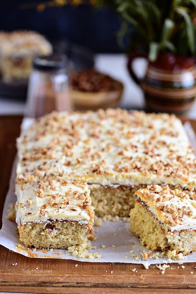 Cut Caramel Butter Pecan Cake With Bourbon Frosting on wood board