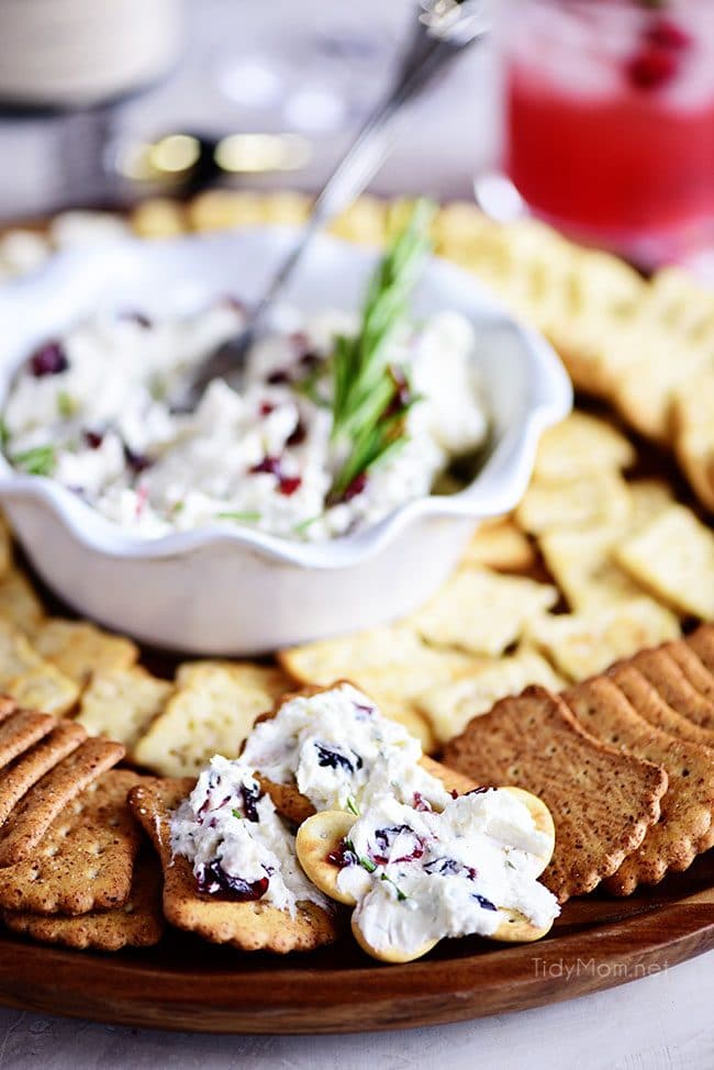 Cranberry Cream Cheese Dip in a bowl on tray with crackers