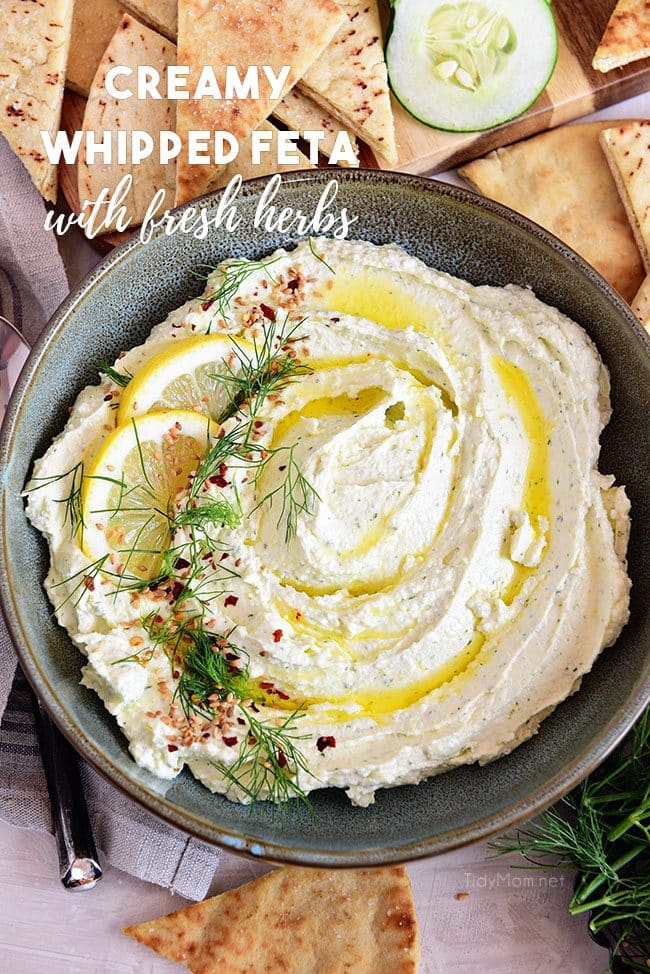 bowl of Whipped Feta with fresh herbs and rosemary olive oil and homemade pita chips