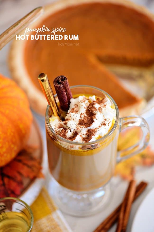 Pumpkin Spice Hot Buttered Rum next to a pumpkin pie