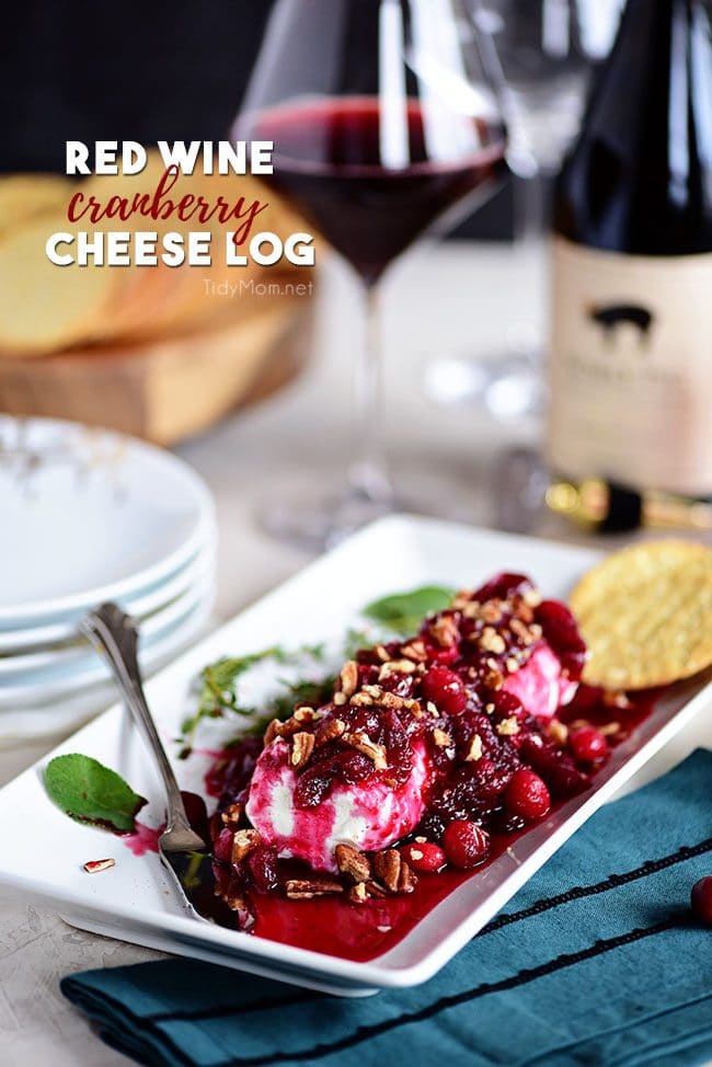 Red Wine Cranberry Cheese Log appetizer with bottle of wine