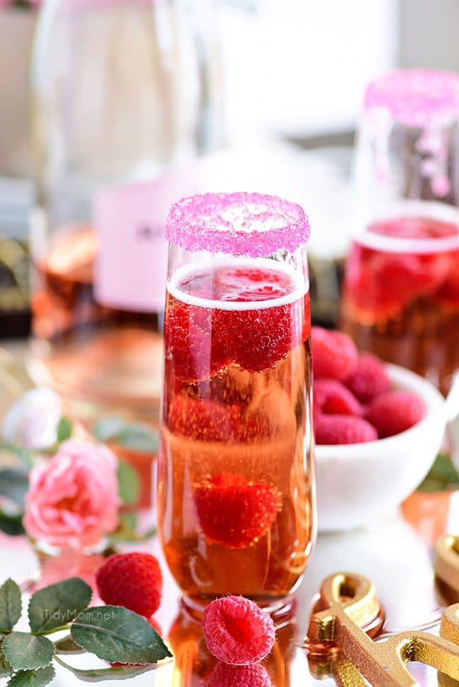 Raspberry Kir Royale cocktail in champagne flute and sugar rim