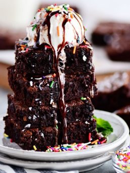 the best brownies stacked with a scoop of ice cream on top
