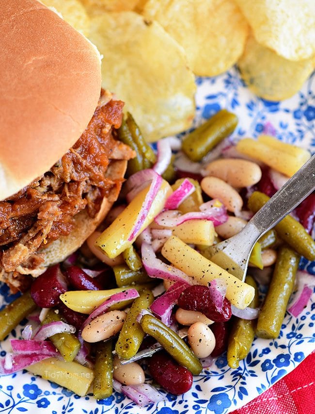 Bean salad on a plate with pulled pork