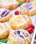 Cream Cheese Danishes with lemon and raspberry on a pan