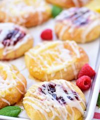 Cream Cheese Danishes with lemon and raspberry on a pan