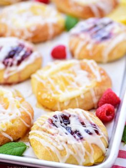 Cream Cheese Danishes with lemon and raspberry on a pan