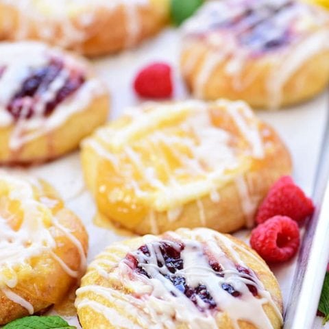 Cream Cheese Danishes with lemon and raspberry on a pan