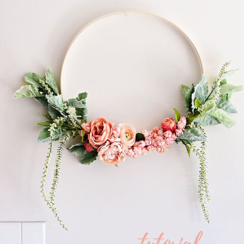 Blush and green spring floral hoop wreath on wall