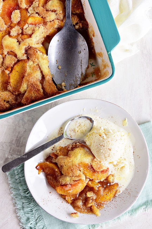 peach cobbler in pan and on a plate flat lay