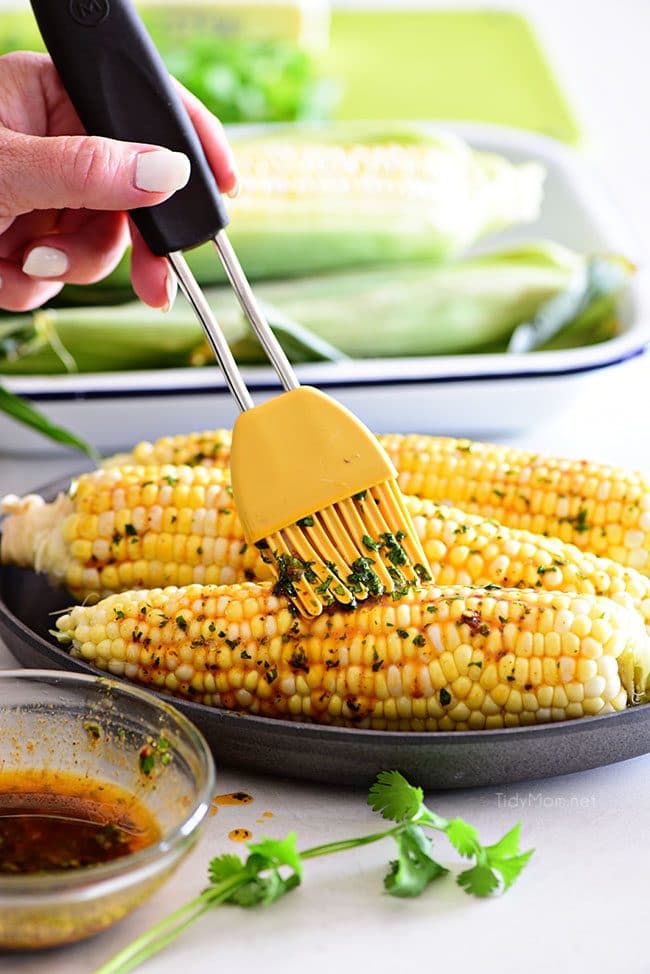 brushing Chili Lime butter on to Corn On The Cob