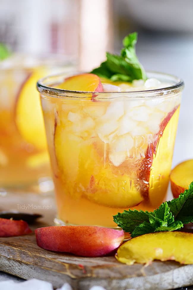 Ginger Peach Bourbon Smash cocktail with fresh peaches and mint