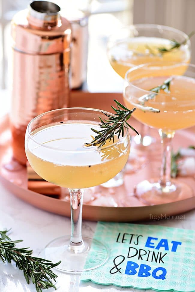 Tray of Bourbon Sour cocktails with smoked rosemary