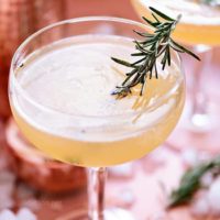 Bourbon Sour with smoked rosemary garnish