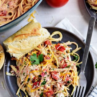 Creamy One-Pot Chicken Spaghetti on a gray plate with french bread