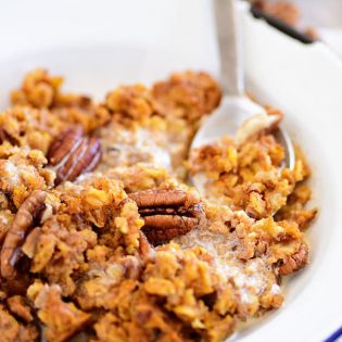 baked pumpkin oatmeal in a bowl with a spoon
