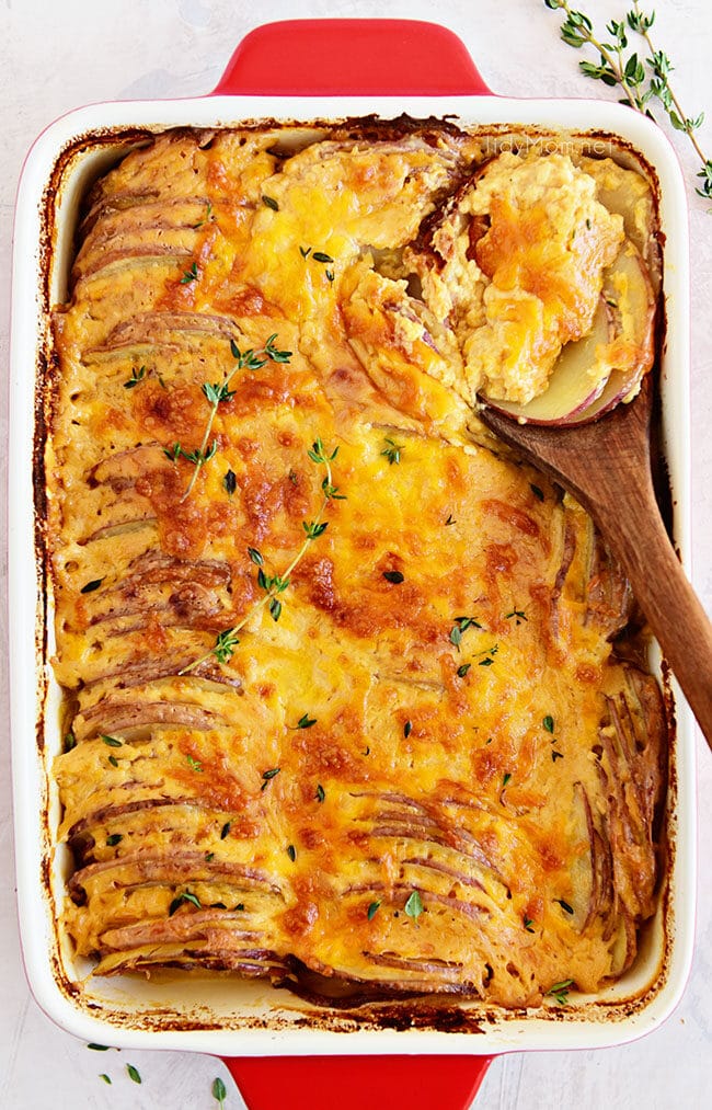 Potatoes au gratin in a red casserole dish