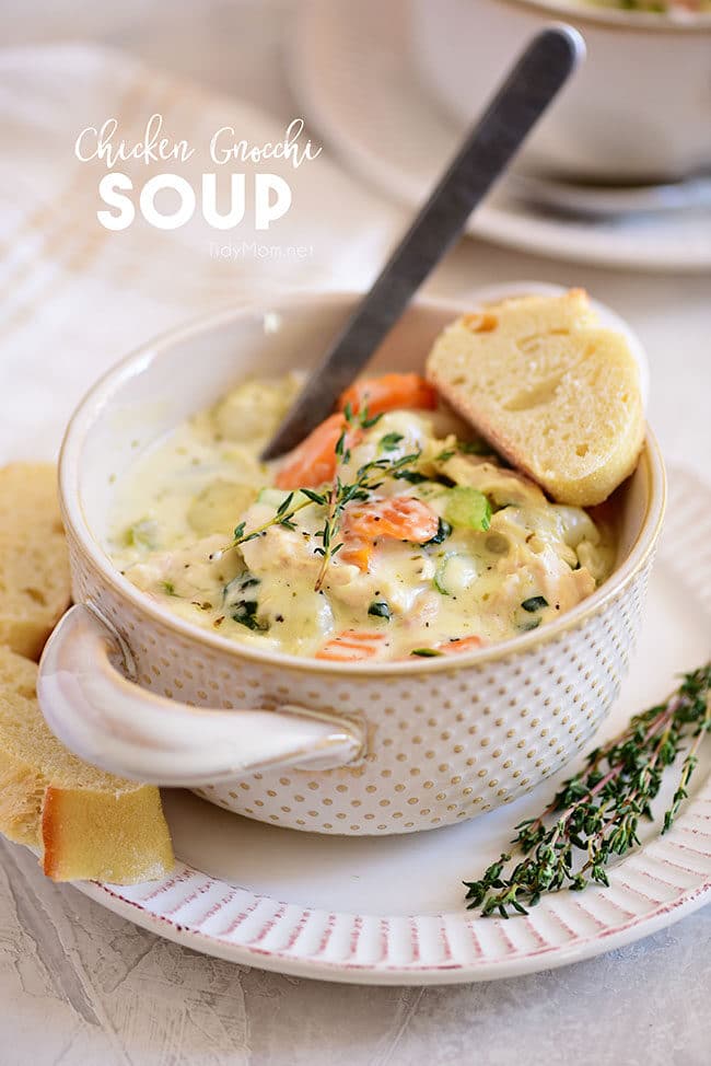 a bowl of creamy chicken gnocchi soup with a slice of bread