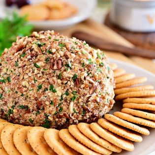 classic cheese ball on a plate with crackers