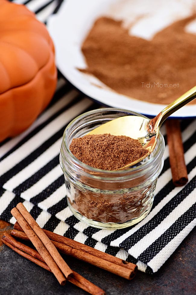 homemade pumpkin pie spice in a jar with a gold spoon