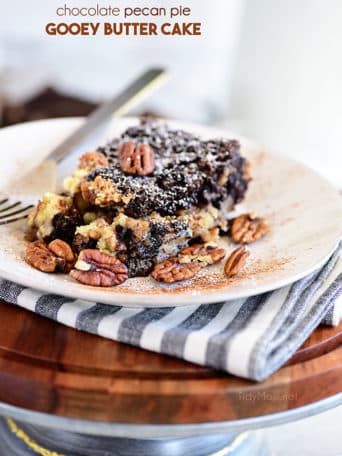 Chocolate Pecan Pie Gooey Butter Cake with a fork on a white plate