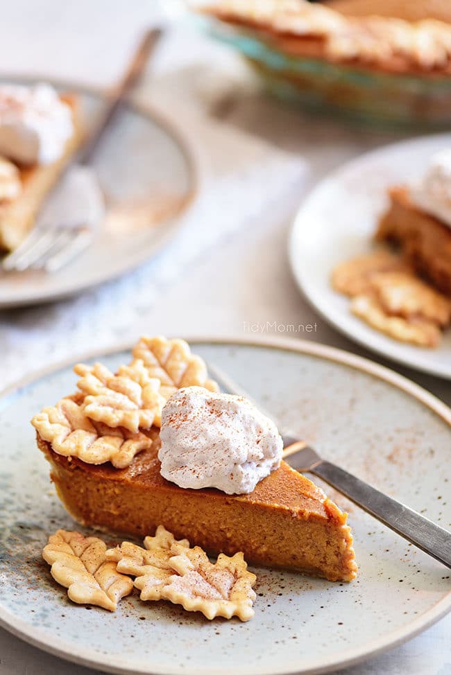 pumpkin pie with leaf cut-outs and whipped cream