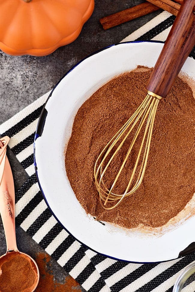 homemade pumpkin pie spice in a bowl with a whisk