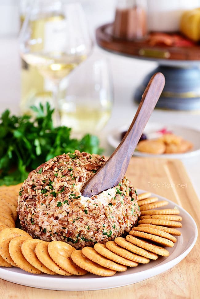 easy cheese ball on plate with crackers and spreading knife
