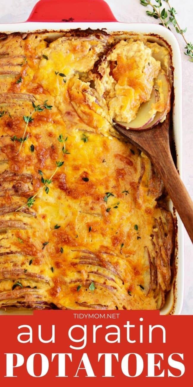 cheese potatoes in a red pan and a wooden spoon