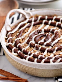 Cinnamon Roll Baked Oatmeal in round dish