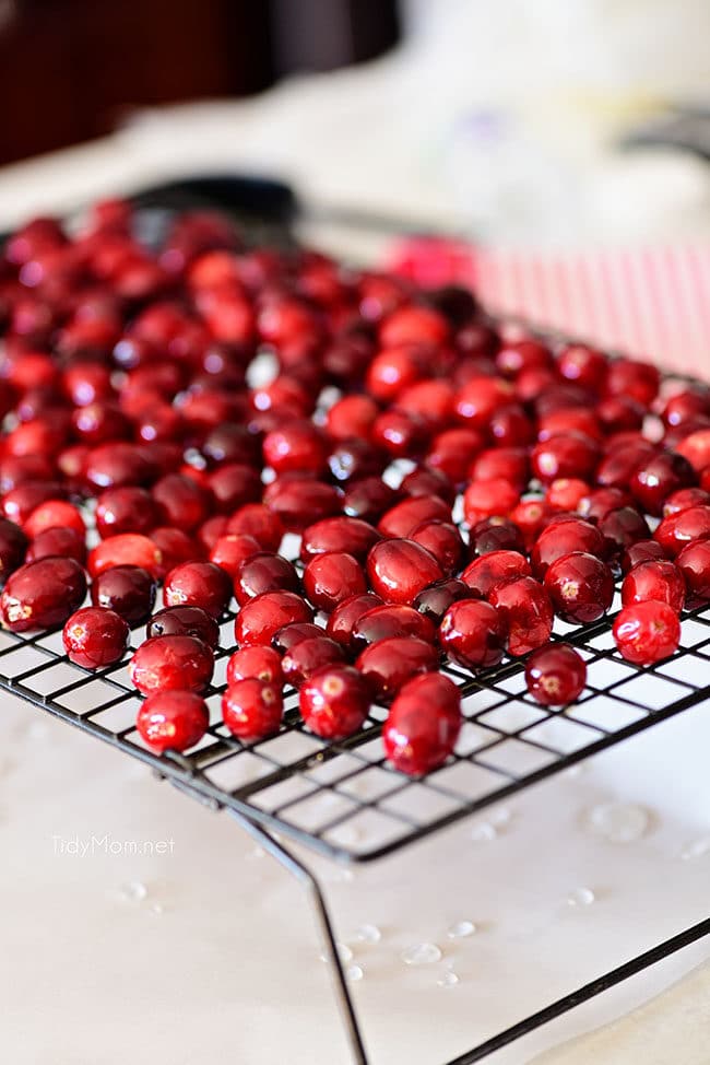 cranberries in syrup drying on a rack