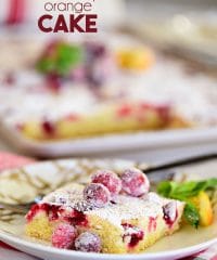 a piece of Super moist Cranberry Orange Cake topped with sugared cranberries