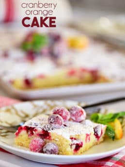 a piece of Super moist Cranberry Orange Cake topped with sugared cranberries