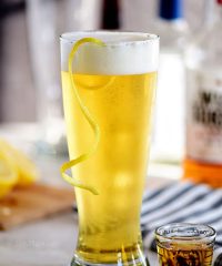 boilermaker beer cocktail with a lemon twist in a frosty glass