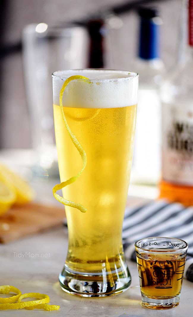 boilermaker beer cocktail with a lemon twist in a frosty glass