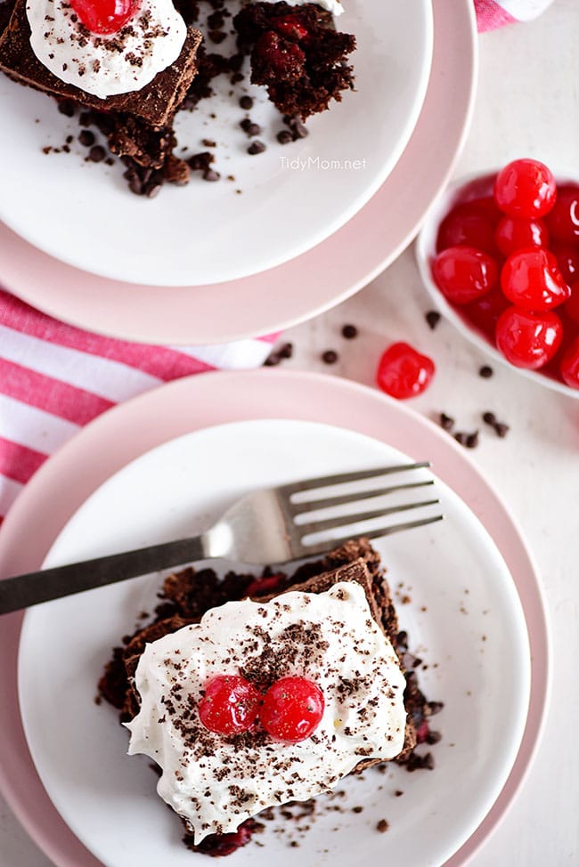 2 pieces of a piece of chocolate cherry cake on plates
