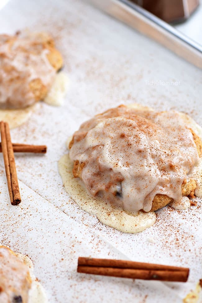 cinnamon raisin biscuit with sweet icing on a sheet pan