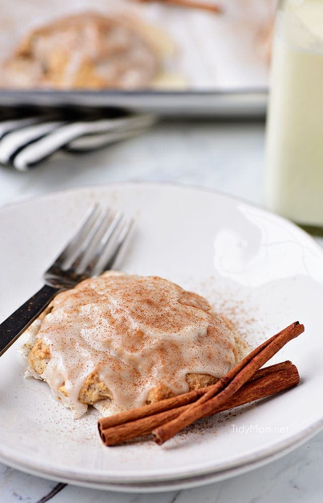 cinnamon raisin biscuit with sweet icing on a white plate