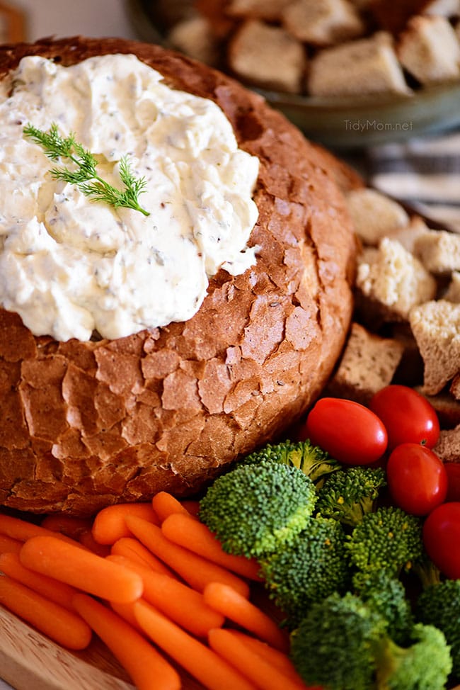 Rye Bread Bowl Dip on a tray with cubed bread and veggies