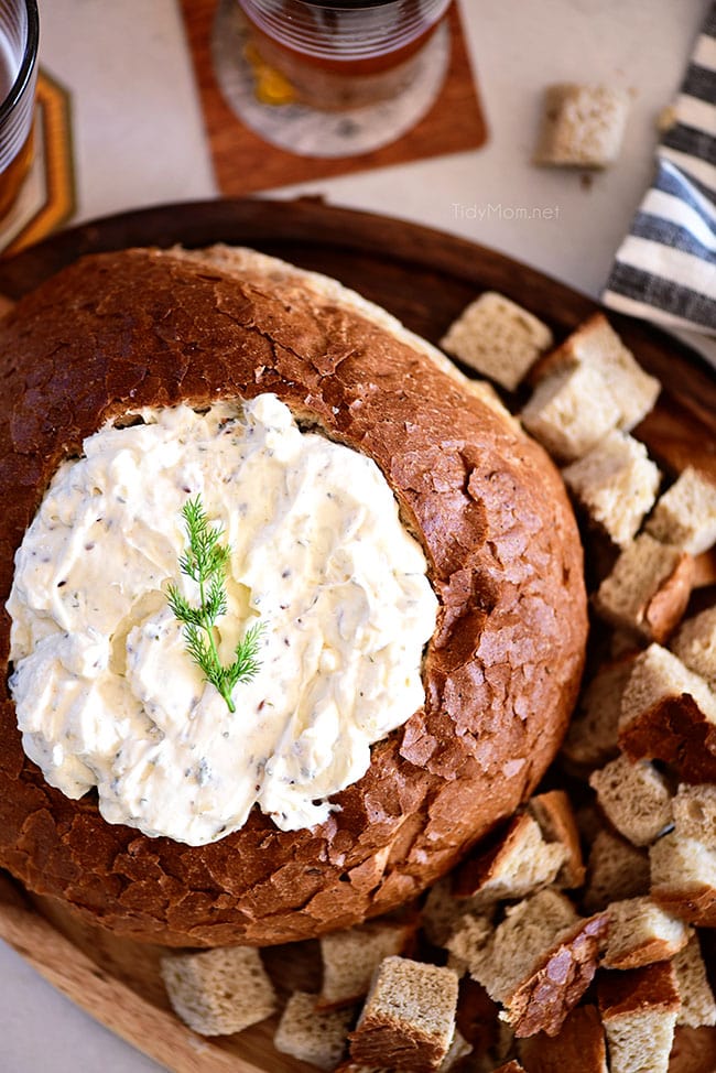 Rye Bread Bowl Dip on a tray with cubed bread around it