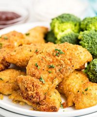 chicken tenders on a plate with broccoli